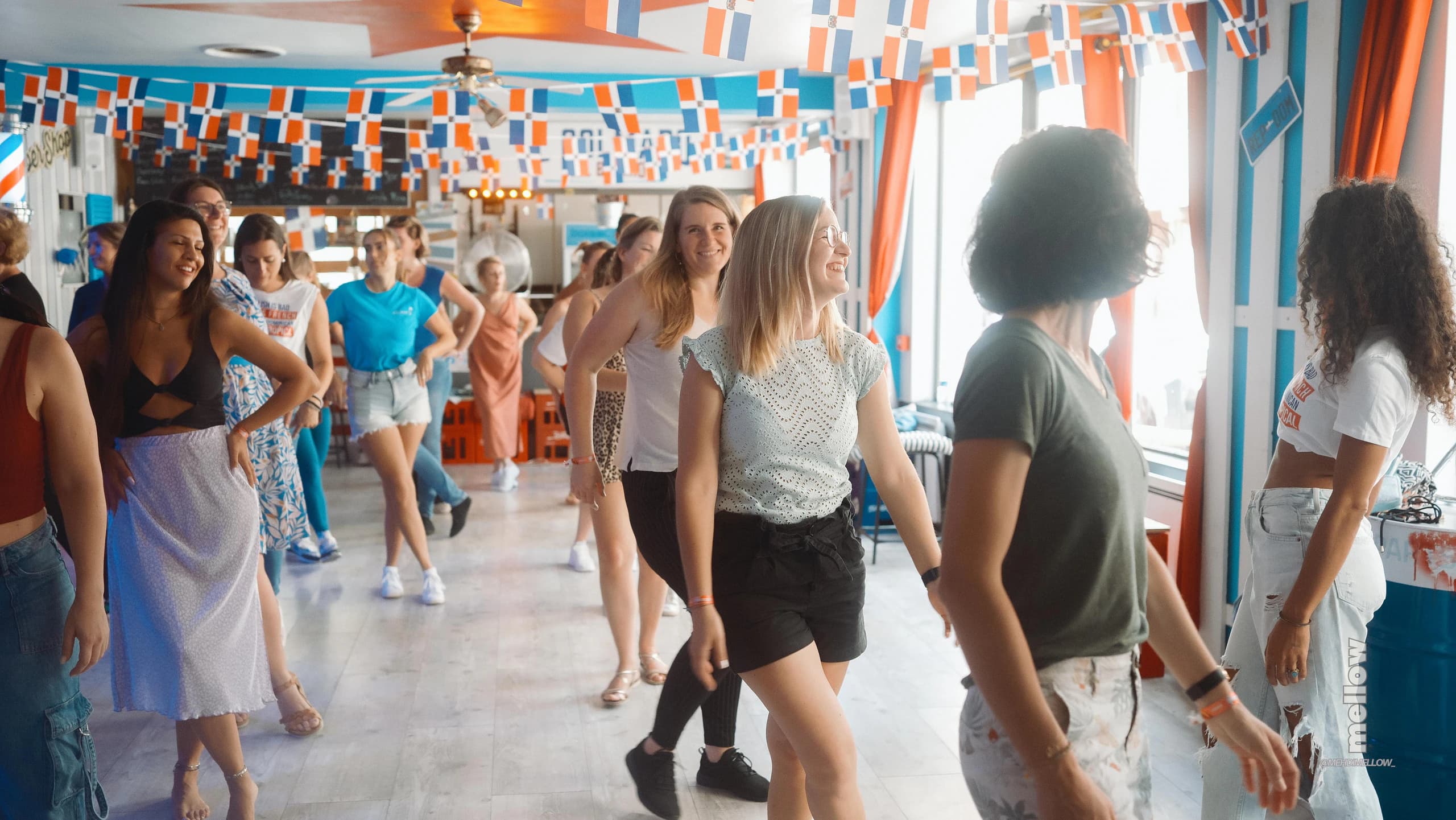 Dancers sharing a joyful moment at a Dominican Swag workshop